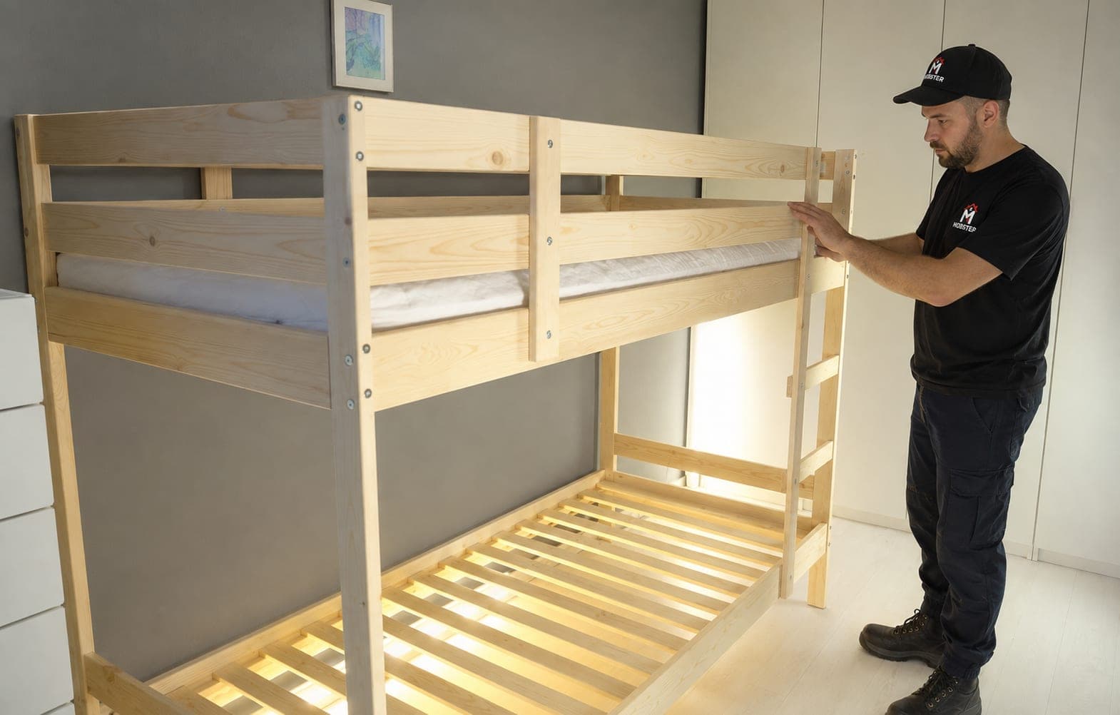 A Mobster fitting the ladder to a newly assembled pine bunk bed