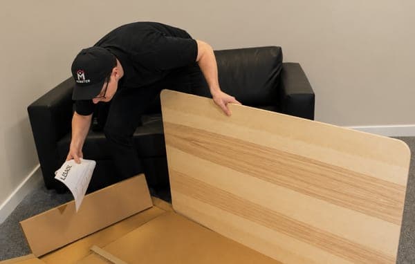 A Mobster unpacking a flat-pack desk before assembly